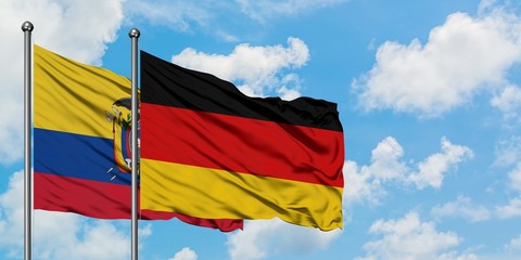 Ecuador and Germany flag waving in the wind against white cloudy blue sky together. Diplomacy concept, international relations.