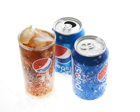 POLTAVA, UKRAINE - MARCH 22, 2018: cold pepsi and a glass on a white background.Pepsi is carbonated soft drink produced by PepsiCo. Pepsi was created and developed in 1893