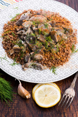 Stewed turkey stomachs with vegetables and buckwheat in a bowl