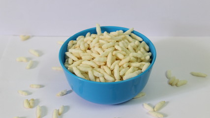 Puffed rice on the blue bowl with white background