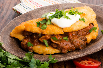 Potato pancakes with meat, vegetable, tomato and parsley