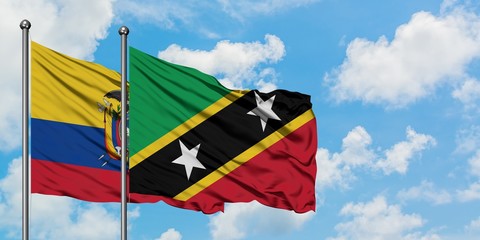 Ecuador and Saint Kitts And Nevis flag waving in the wind against white cloudy blue sky together. Diplomacy concept, international relations.