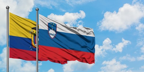 Ecuador and Slovenia flag waving in the wind against white cloudy blue sky together. Diplomacy concept, international relations.