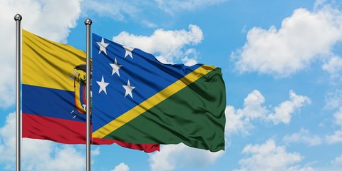 Ecuador and Solomon Islands flag waving in the wind against white cloudy blue sky together....