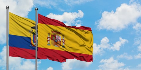 Ecuador and Spain flag waving in the wind against white cloudy blue sky together. Diplomacy...