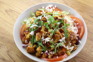 Delicious chicken salad in a white plate.