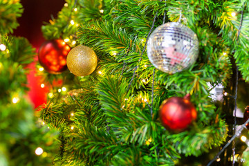 Beautiful Christmas tree with decor against blurred lights on background.