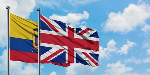 Ecuador and United Kingdom flag waving in the wind against white cloudy blue sky together....