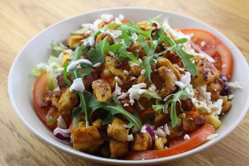 Delicious chicken salad in a white plate.