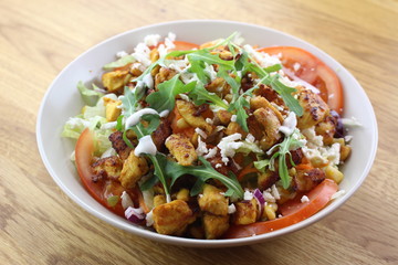 Delicious chicken salad in a white plate.
