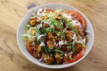 Delicious chicken salad in a white plate.