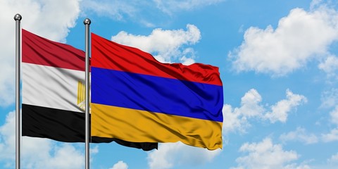 Egypt and Armenia flag waving in the wind against white cloudy blue sky together. Diplomacy concept, international relations.