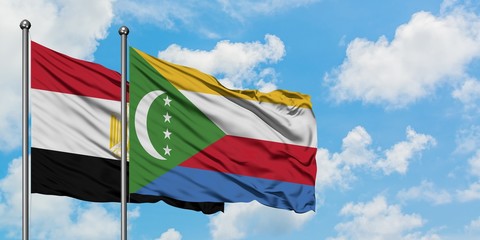 Egypt and Comoros flag waving in the wind against white cloudy blue sky together. Diplomacy concept, international relations.