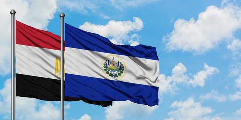 Egypt and El Salvador flag waving in the wind against white cloudy blue sky together. Diplomacy concept, international relations.