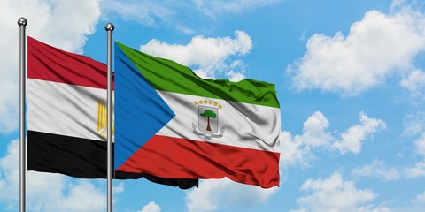 Egypt and Equatorial Guinea flag waving in the wind against white cloudy blue sky together. Diplomacy concept, international relations.