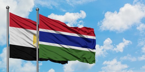 Egypt and Gambia flag waving in the wind against white cloudy blue sky together. Diplomacy concept,...