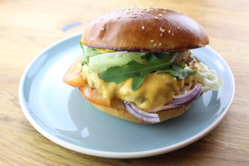 Delicious classic burger isolated on a white plate.