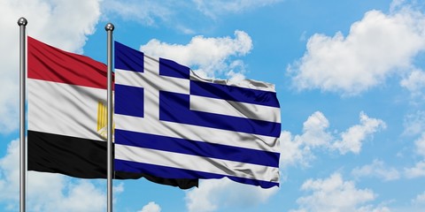 Egypt and Greece flag waving in the wind against white cloudy blue sky together. Diplomacy concept, international relations.