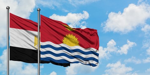 Egypt and Kiribati flag waving in the wind against white cloudy blue sky together. Diplomacy concept, international relations.