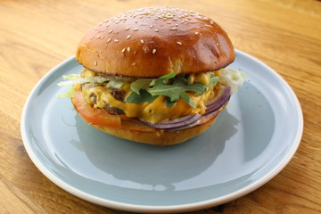 Delicious classic burger isolated on a white plate.