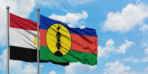 Egypt and New Caledonia flag waving in the wind against white cloudy blue sky together. Diplomacy concept, international relations.