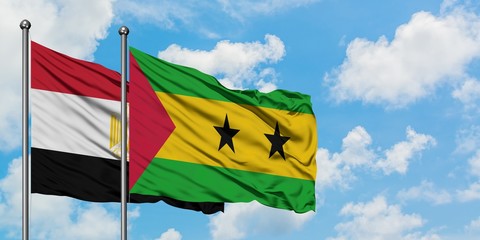 Egypt and Sao Tome And Principe flag waving in the wind against white cloudy blue sky together....