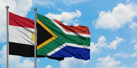 Egypt and South Africa flag waving in the wind against white cloudy blue sky together. Diplomacy concept, international relations.