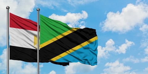 Egypt and Tanzania flag waving in the wind against white cloudy blue sky together. Diplomacy concept, international relations.