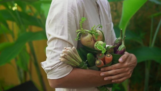 Eco-friendly product packaging concept. Vegetables wrapped in a banana leaf, as an alternative to a plastic bag. Zero waste concept. Alternative packaging