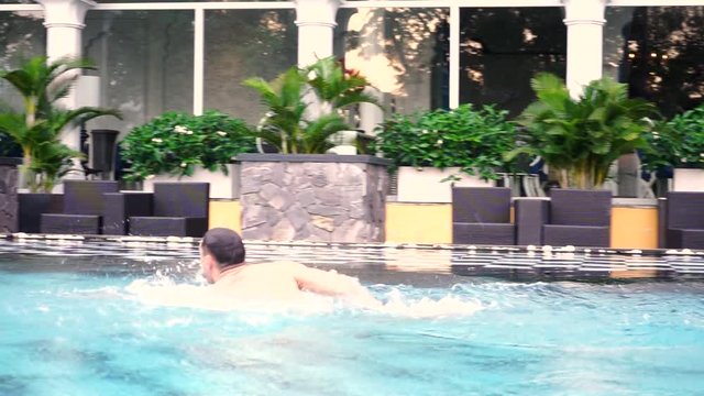 Leisure activities in the pool, swimming and diving.