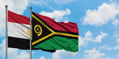Egypt and Vanuatu flag waving in the wind against white cloudy blue sky together. Diplomacy concept, international relations.