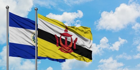 El Salvador and Brunei flag waving in the wind against white cloudy blue sky together. Diplomacy...