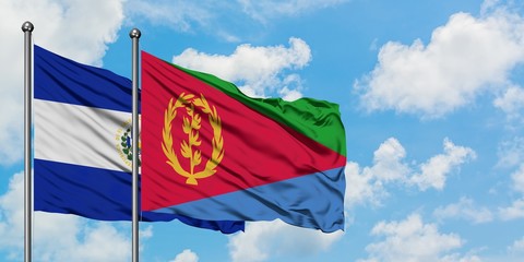 El Salvador and Eritrea flag waving in the wind against white cloudy blue sky together. Diplomacy concept, international relations.