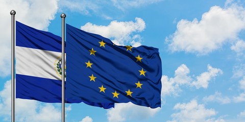 El Salvador and European Union flag waving in the wind against white cloudy blue sky together. Diplomacy concept, international relations.