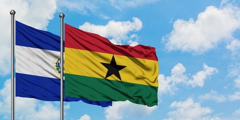 El Salvador and Ghana flag waving in the wind against white cloudy blue sky together. Diplomacy concept, international relations.