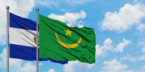El Salvador and Mauritania flag waving in the wind against white cloudy blue sky together. Diplomacy concept, international relations.