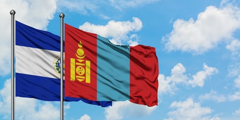El Salvador and Mongolia flag waving in the wind against white cloudy blue sky together. Diplomacy concept, international relations.