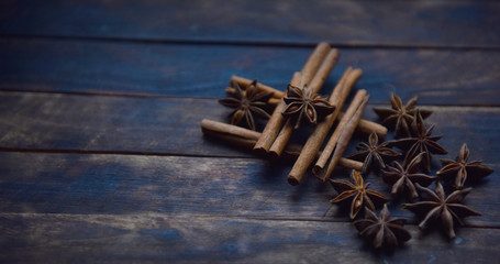 Cassia sticks and star anise on a brown background