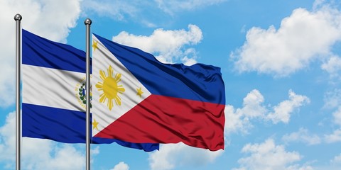 El Salvador and Philippines flag waving in the wind against white cloudy blue sky together. Diplomacy concept, international relations.