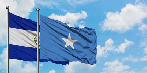 El Salvador and Somalia flag waving in the wind against white cloudy blue sky together. Diplomacy concept, international relations.