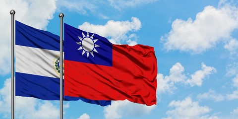 El Salvador and Taiwan flag waving in the wind against white cloudy blue sky together. Diplomacy...