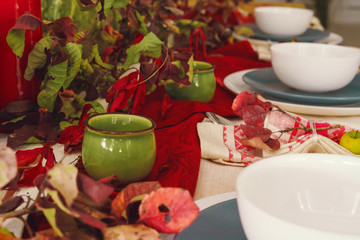 Stylish thanksgiving autumn table decor with pumpkin and dried branches