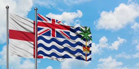 England and British Indian Ocean Territory flag waving in the wind against white cloudy blue sky together. Diplomacy concept, international relations.