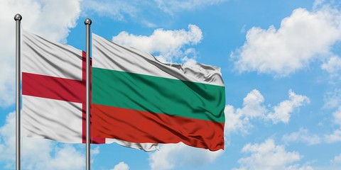 England and Bulgaria flag waving in the wind against white cloudy blue sky together. Diplomacy...