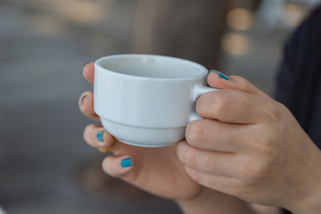 Woman drinking coffee in hand