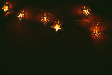 Beautiful bokeh light of star shaped garland in the dark
