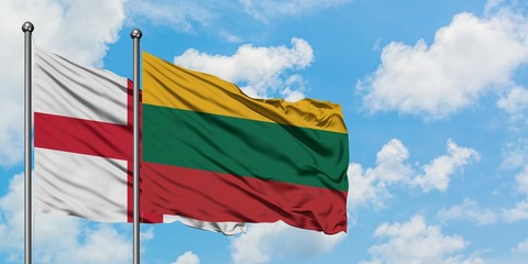 England and Lithuania flag waving in the wind against white cloudy blue sky together. Diplomacy concept, international relations.