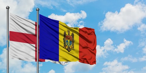 England and Moldova flag waving in the wind against white cloudy blue sky together. Diplomacy concept, international relations.