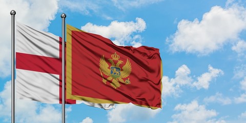 England and Montenegro flag waving in the wind against white cloudy blue sky together. Diplomacy concept, international relations.