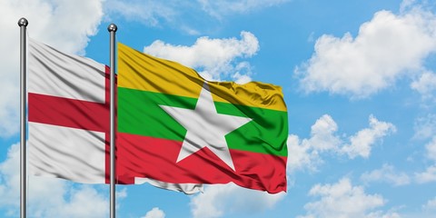 England and Myanmar flag waving in the wind against white cloudy blue sky together. Diplomacy concept, international relations.